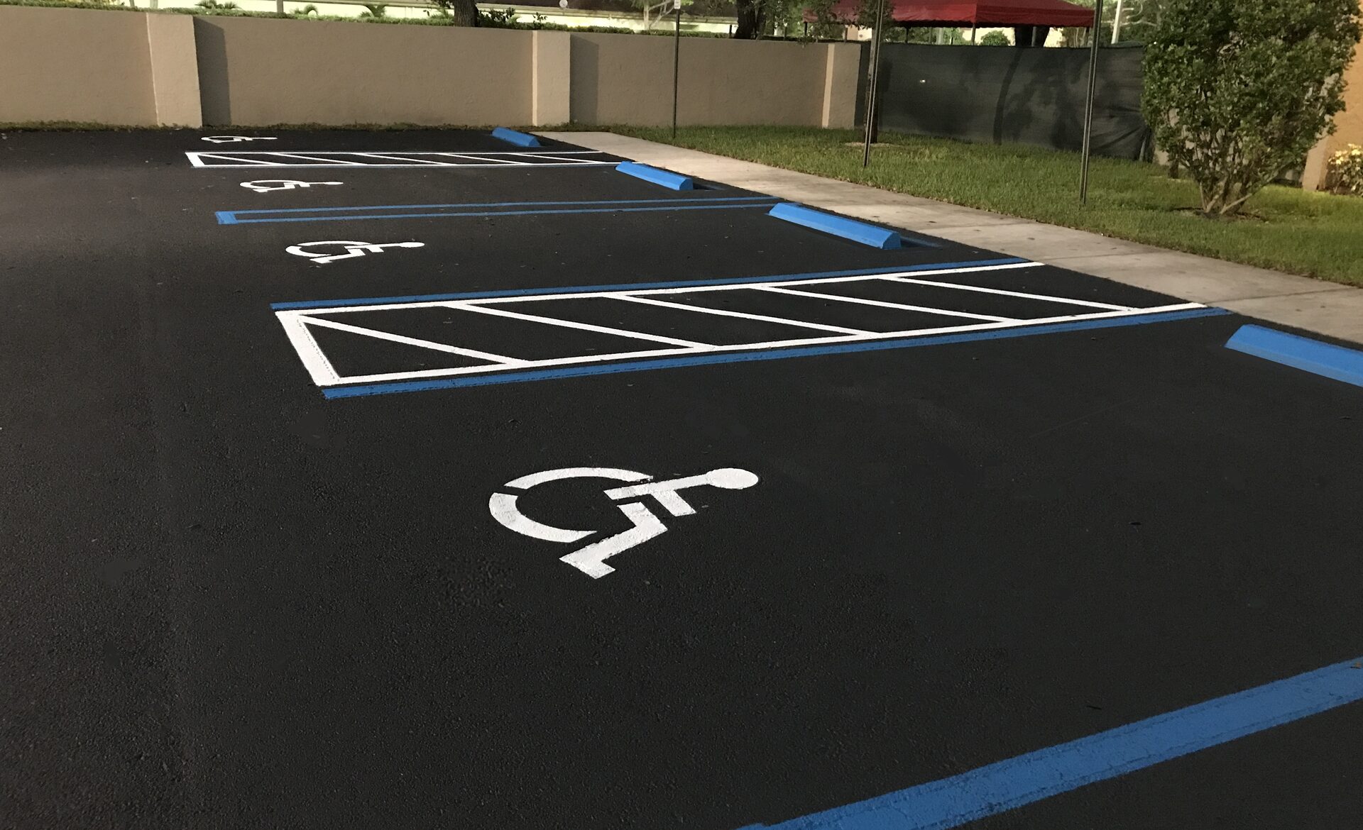 Freshly sealcoated and striped parking lot. Parking Lot Maintenance service.
